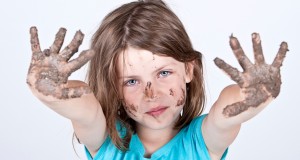 Shot of a Young Girl with Dirty Hands and Face